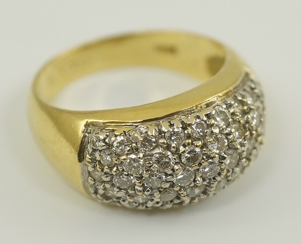 A modern 18k gold and diamond cluster set domed ring